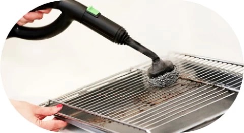 Steam removing grease from oven rack